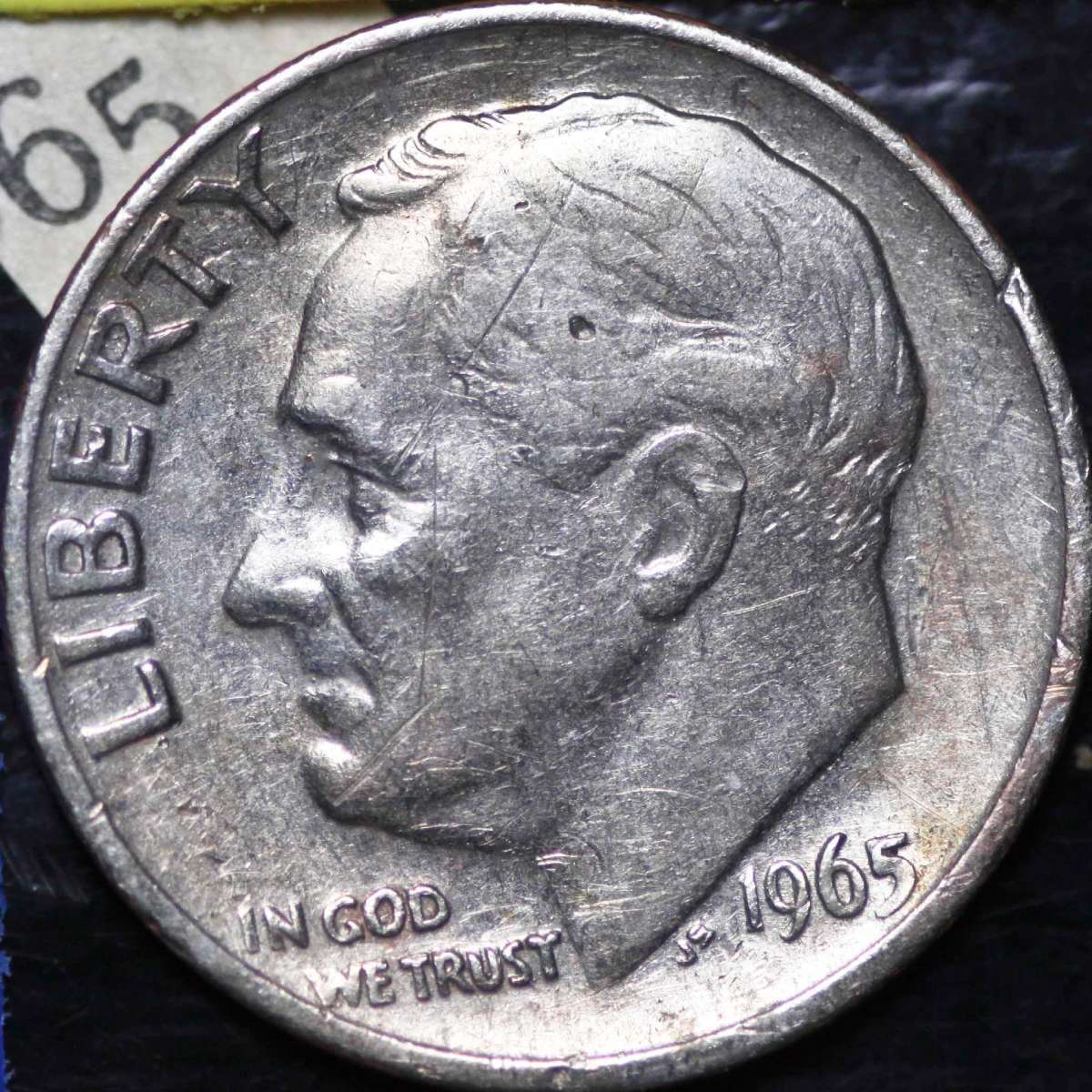 Comparison of 1965 clad dime edge with copper stripe versus 1965 silver transitional error dime with solid silver edge